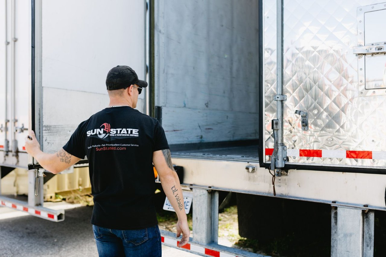 Sun State technician opening the rear doors of a reefer trailer to check the insulated interior