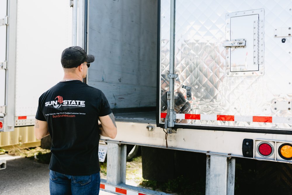 Sun State team member checking a dry van trailer's rear door and panel construction