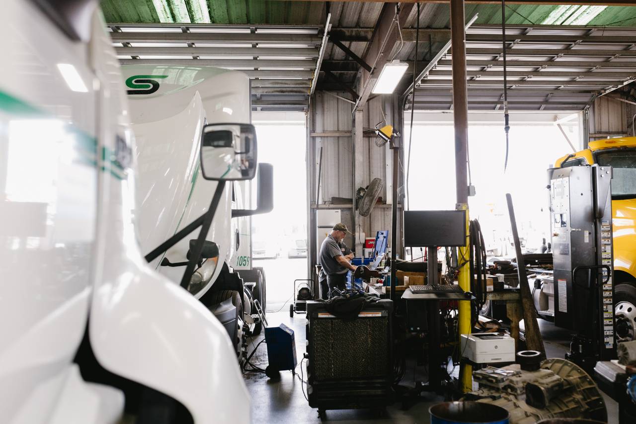 Technician working at a diagnostic computer station inside the Sun State International service shop