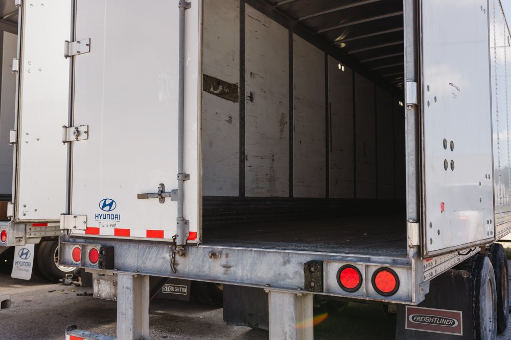 Open rear doors of a Hyundai Translead dry van trailer showing the empty cargo interior