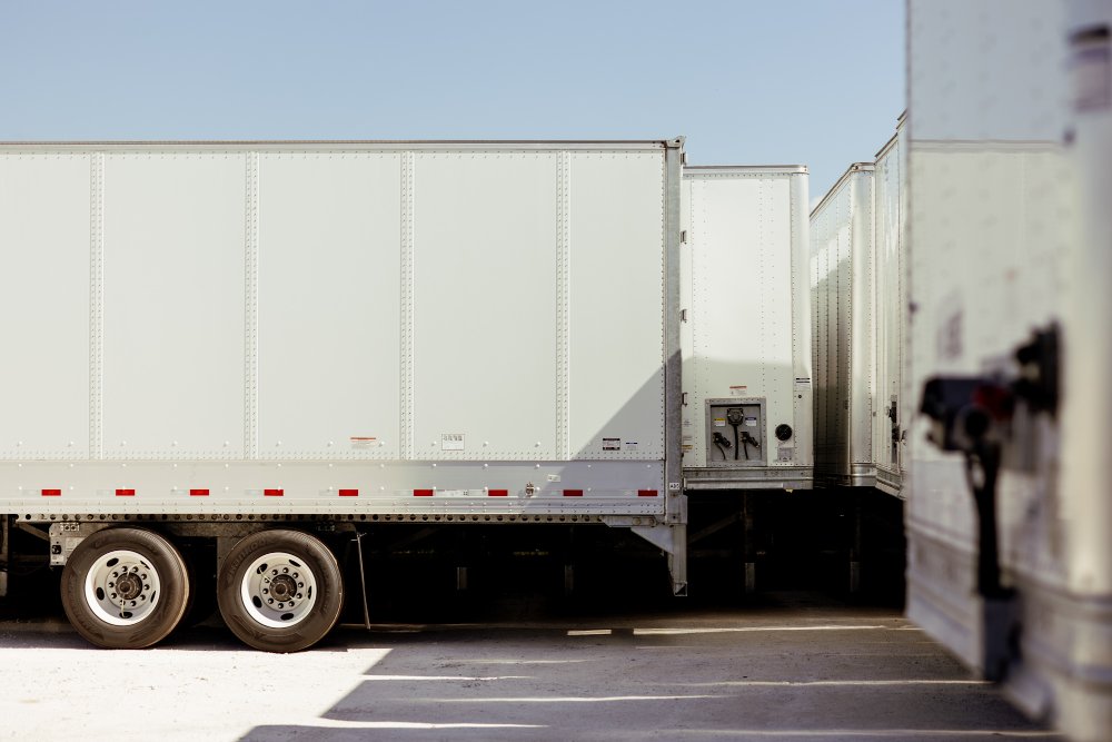 Row of dry van trailer rear doors and connections at Sun State Trailers