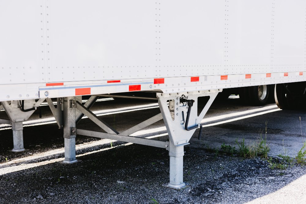 Close-up of a dry van trailer's landing gear and undercarriage detail