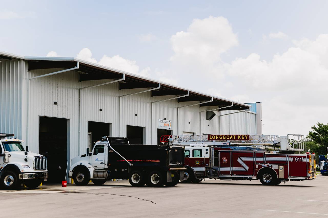 Sun State International service bay exterior with heavy-duty trucks parked outside