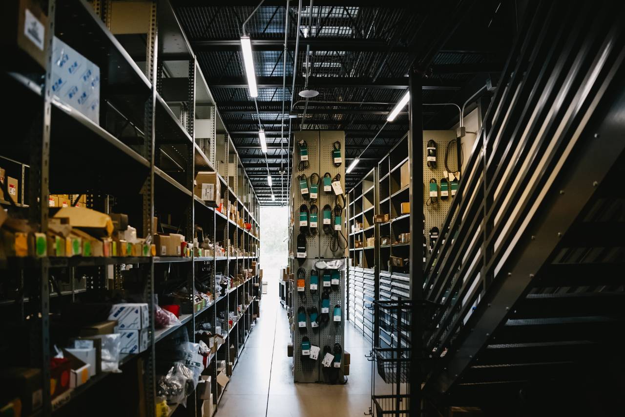 Aisle of shelved truck parts and belts inside the Sun State International parts warehouse