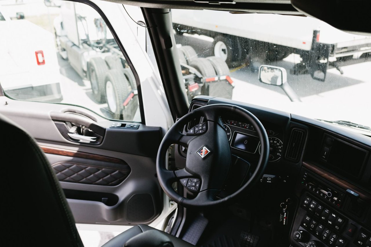 Dashboard and steering wheel view inside an International truck cab