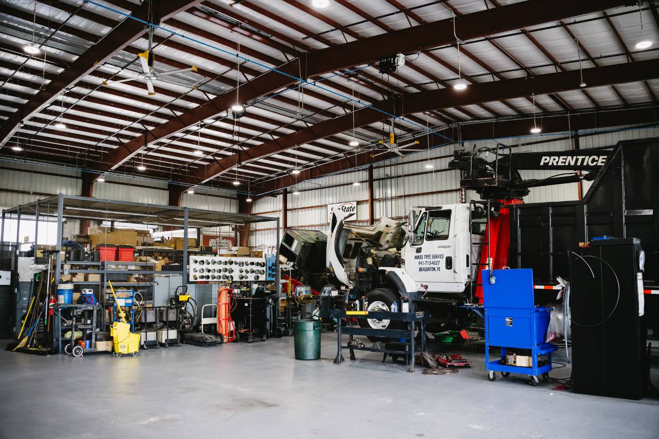 Sun State International service bay with a truck being serviced and parts inventory stocked nearby