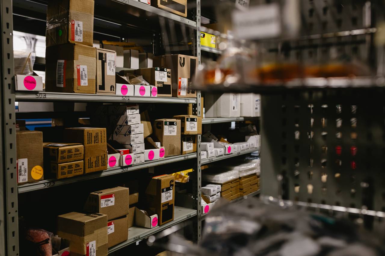 Shelves of labeled International truck parts organized inside the Sun State International warehouse