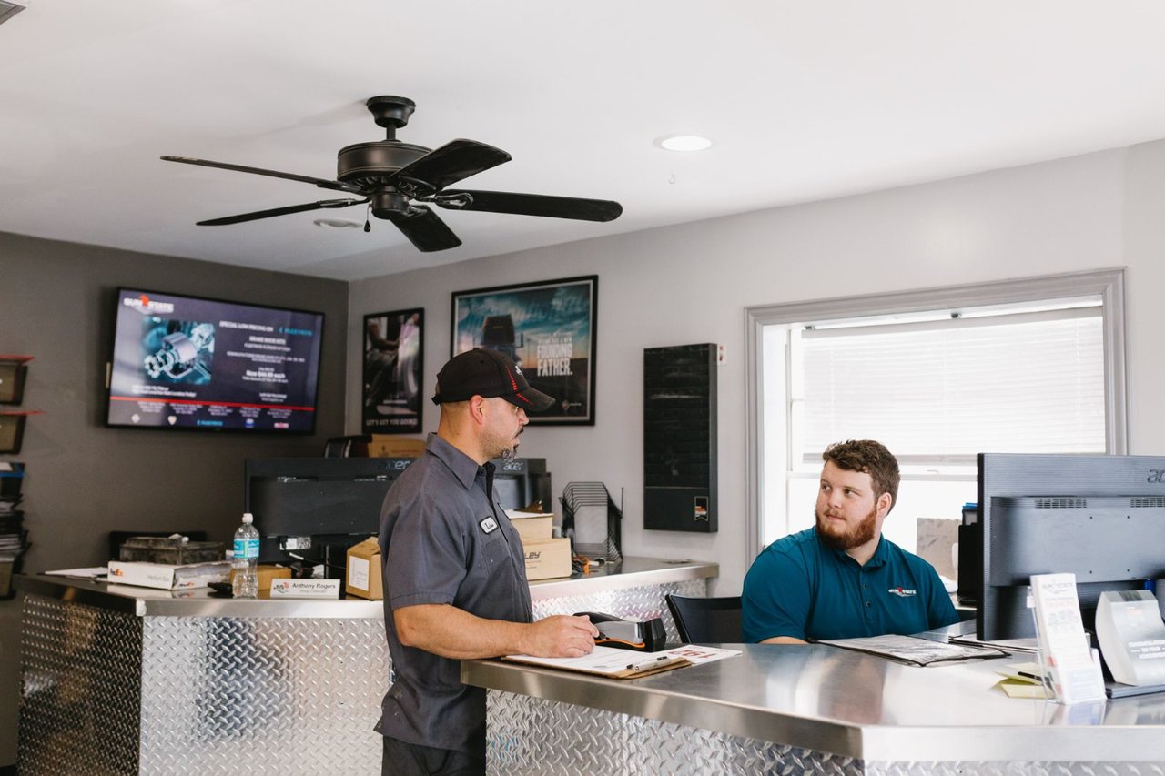 Sun State service advisor and shop foreman reviewing a work order at the front counter