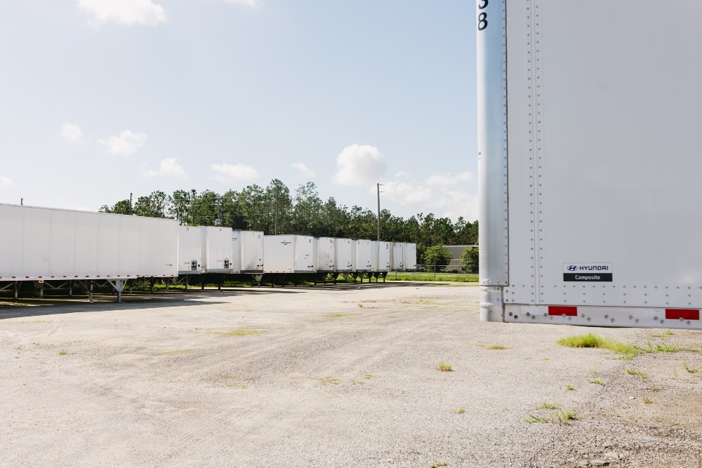Row of dry van trailers side by side at Sun State Trailers showing condition differences