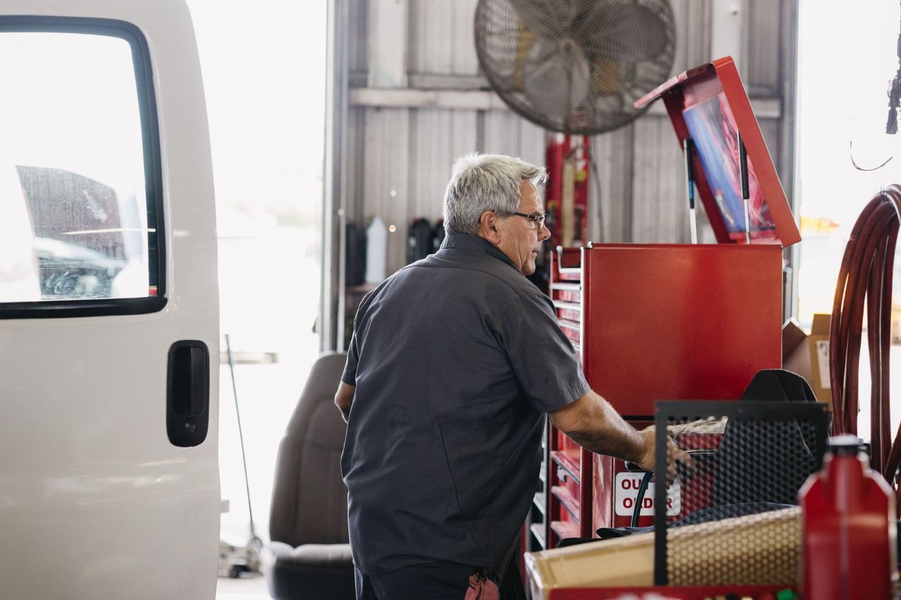 Sun State technician working at the service bench with a red toolbox