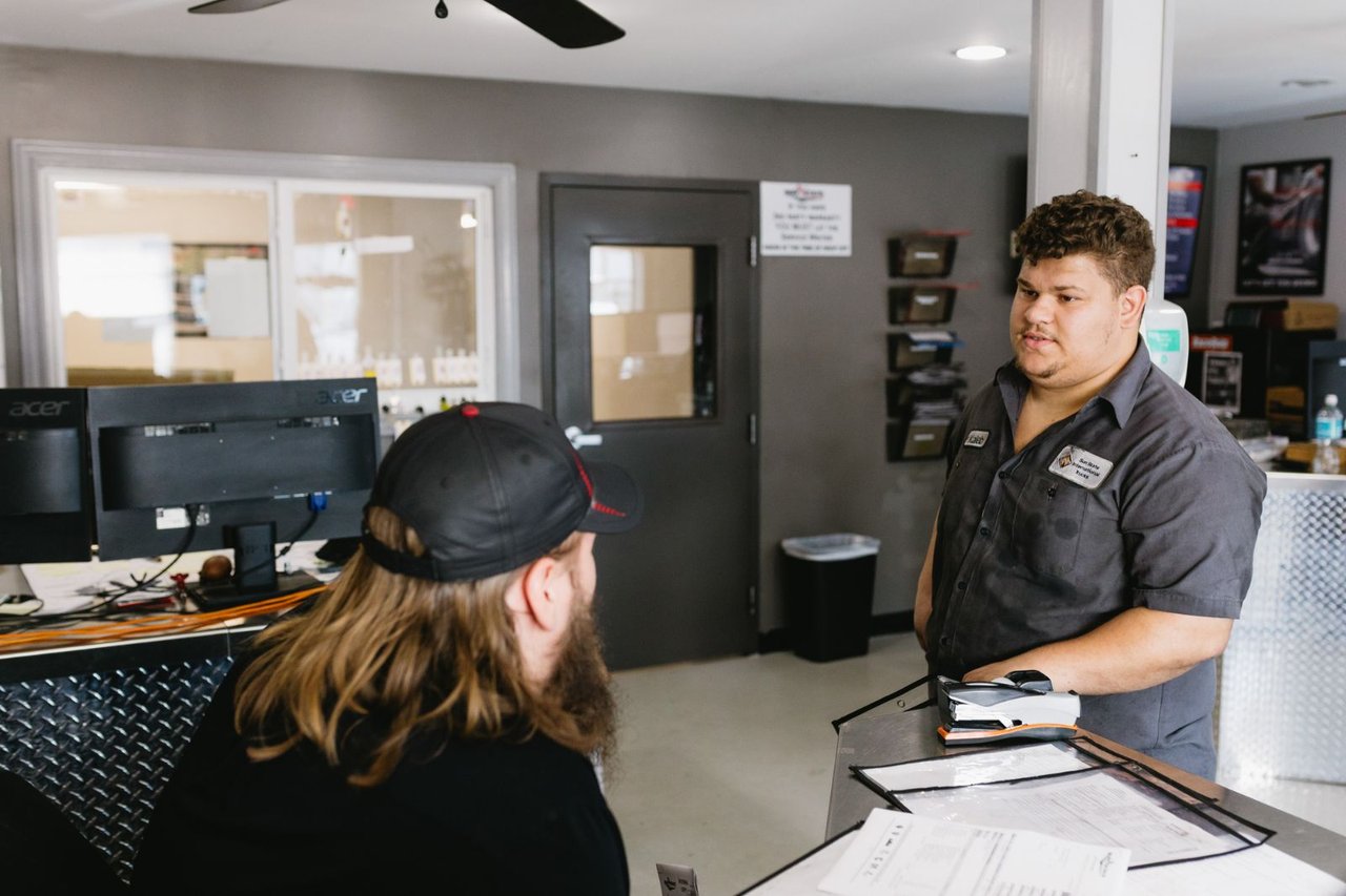 Sun State service advisor speaking with a customer at the front counter