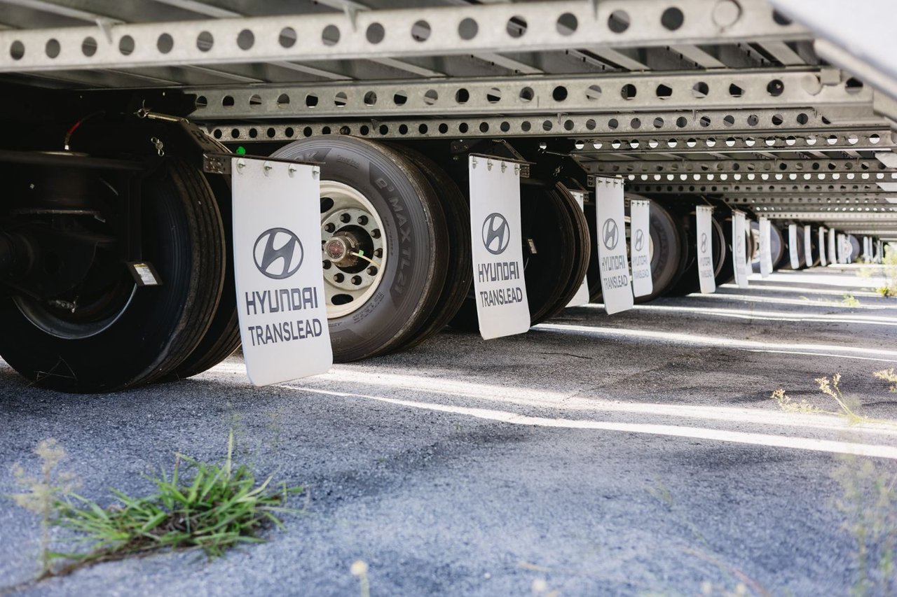 Close-up view under a row of Hyundai Translead trailer axles and mud flaps