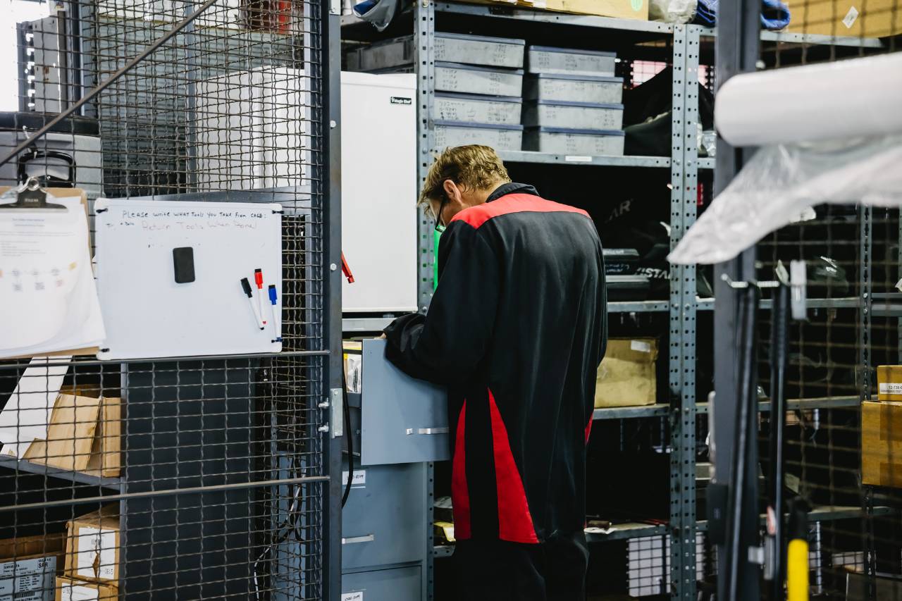 Technician retrieving quality parts from stocked bins at Sun State International