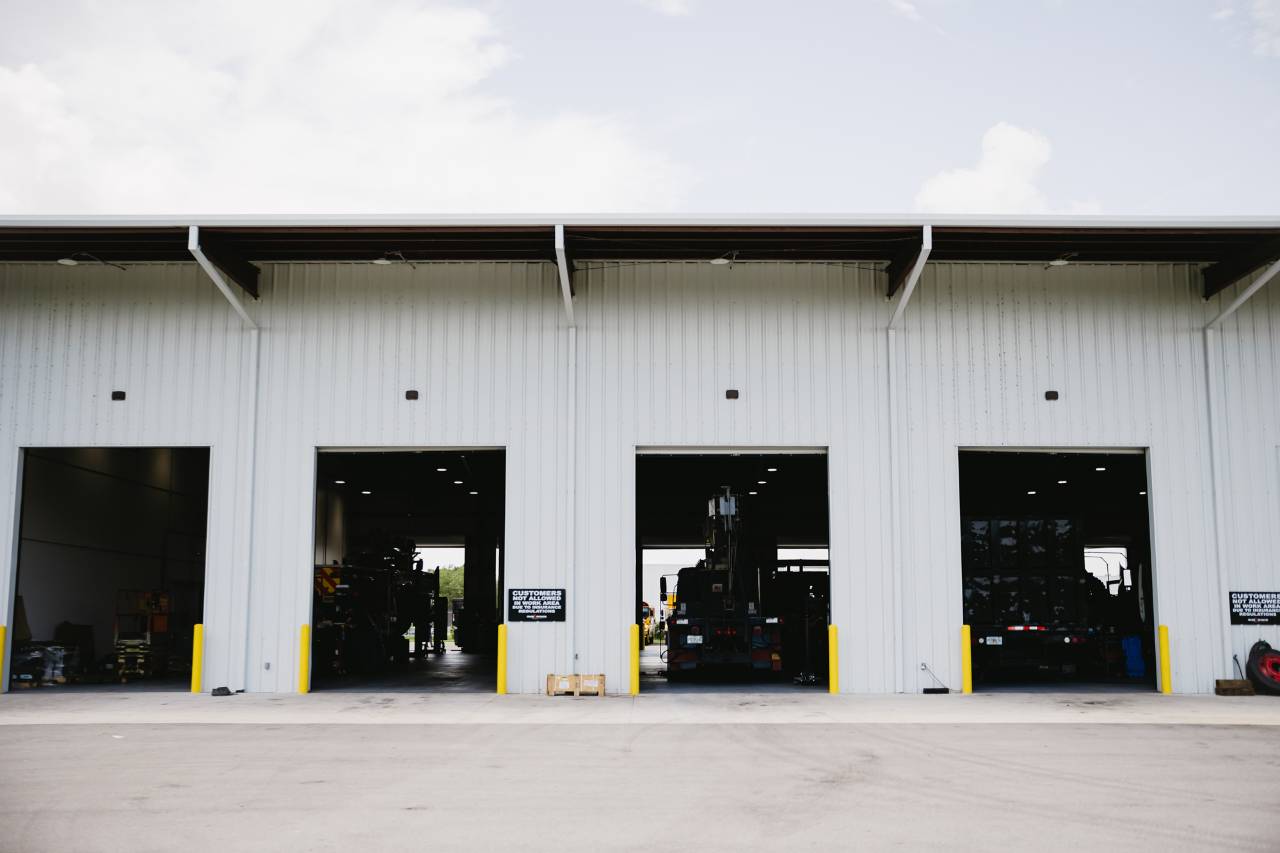 Exterior of Sun State International service center with truck bays ready for maintenance
