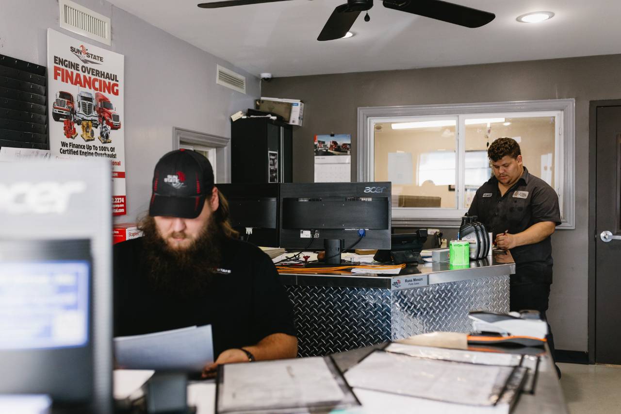 Sun State International parts and service staff working at the front counter