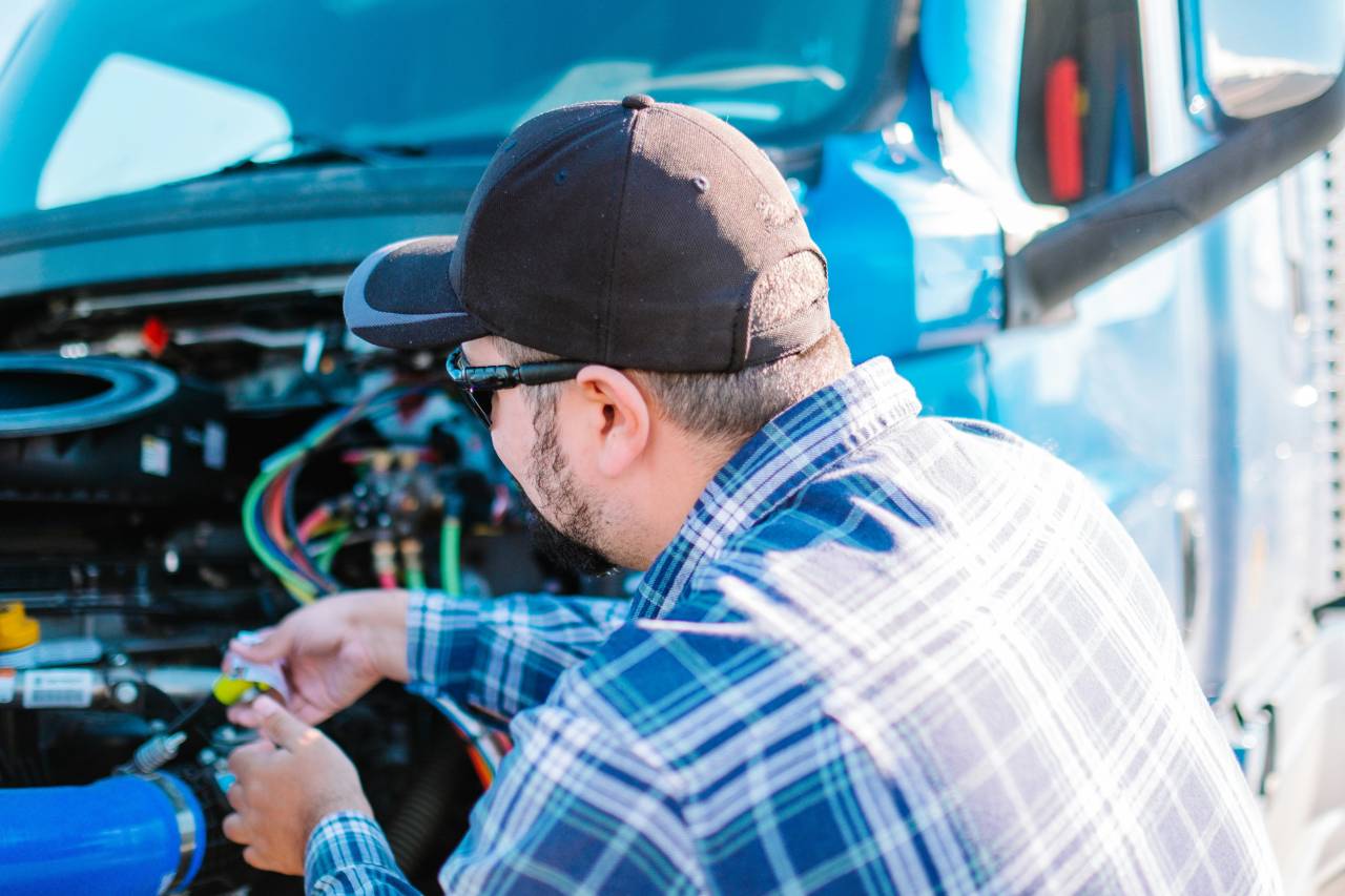 Diesel mechanic performing diagnostics on a semi truck emissions system