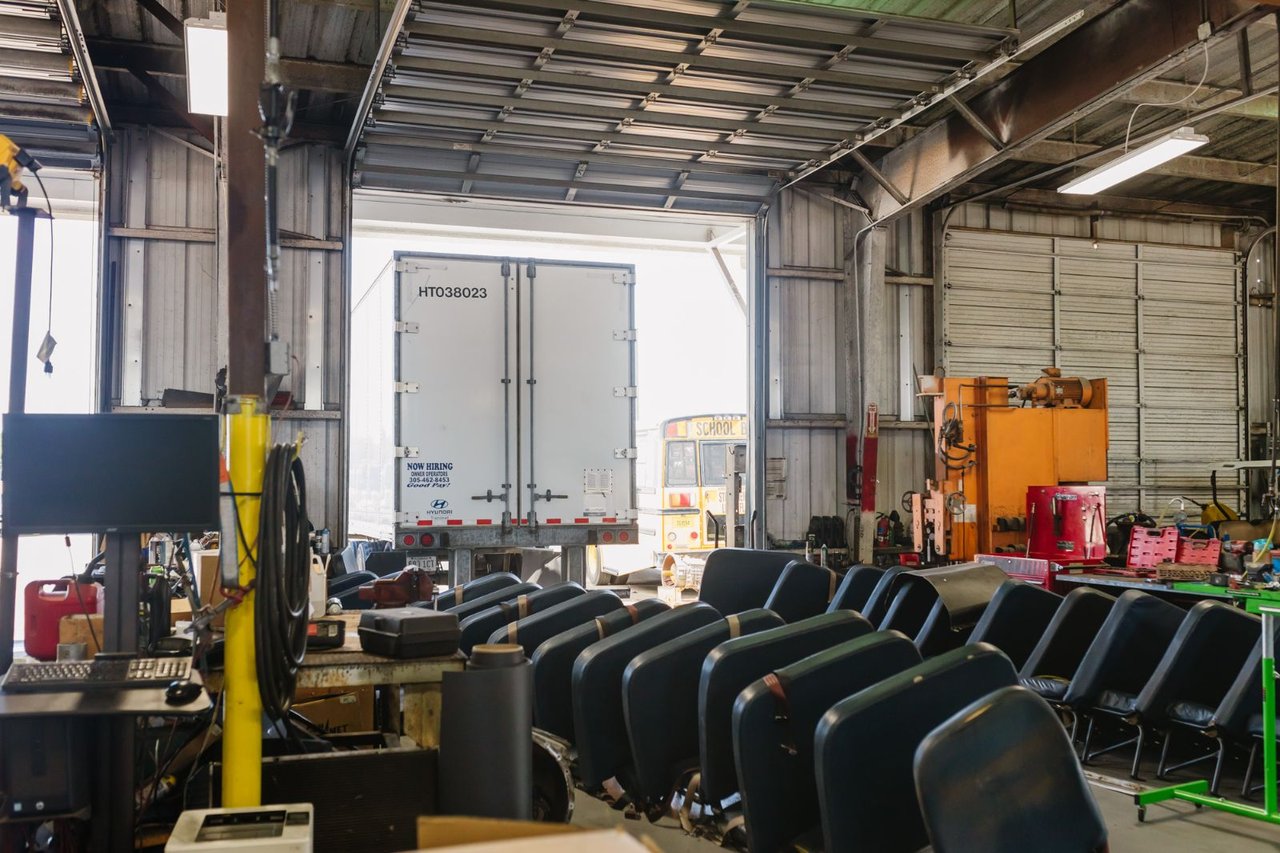 Sun State service bay with trailer parts and a trailer backed up to the open bay door