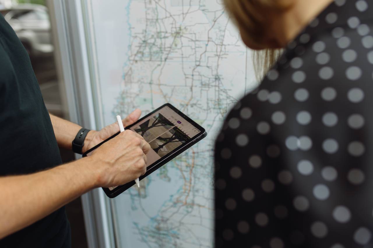 Fleet manager and Sun State International team member reviewing a route map on a tablet
