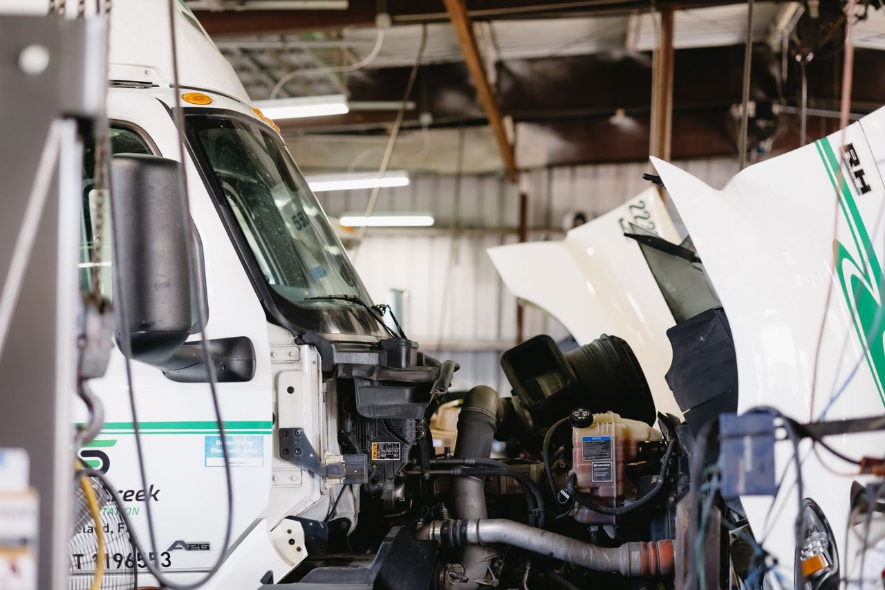 International trucks with hoods raised undergoing engine service in the Sun State shop